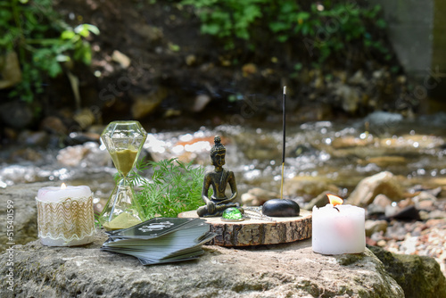 Various items for ritual and fortune-telling on the background of a mountain river.