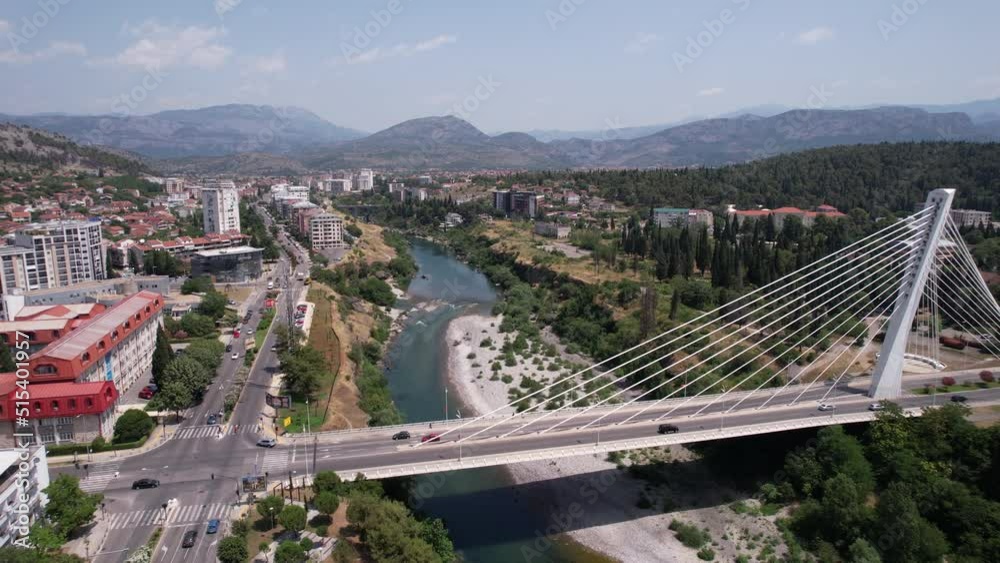 Podgorica, Montenegro. Aerial View, Millennium Bridge Traffic Above Moraca River on Sunny Summer Day, Drone Shot Podgorica, Montenegro. Aerial View, Millennium Bridge Traffic Above Moraca River on Sunny Summer Day, Drone Shot