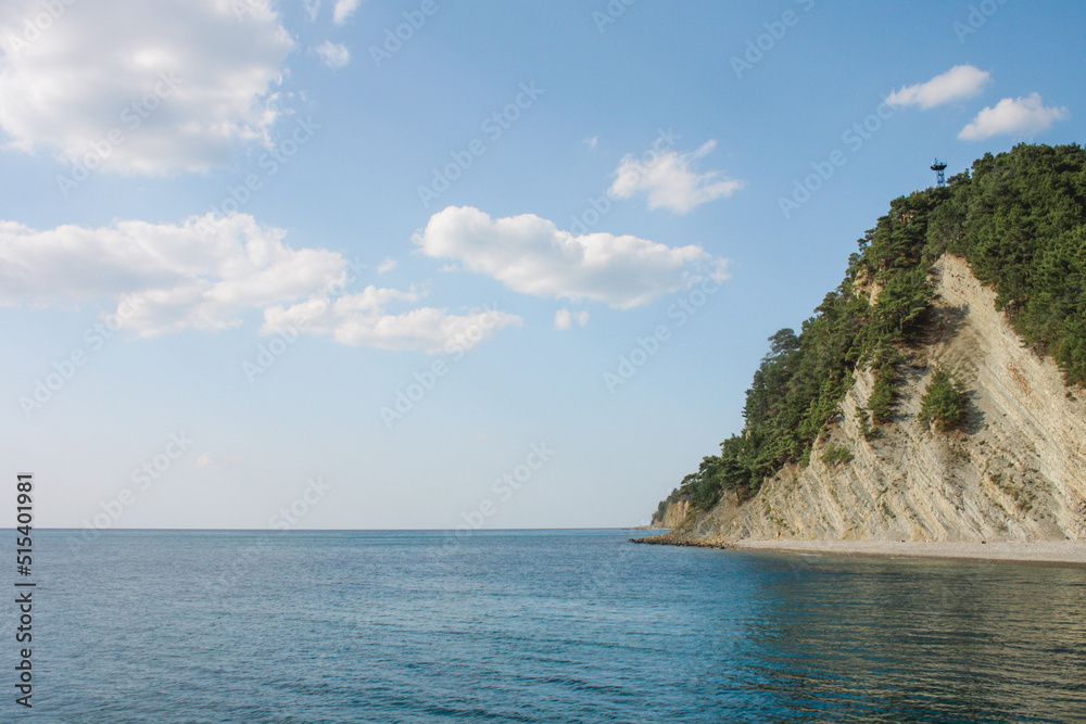 View of the mountain landscape. Blue sky. Blue sea on the background of mountains. Panoramic sea and mountain views. The white mountains are washed by the sea.