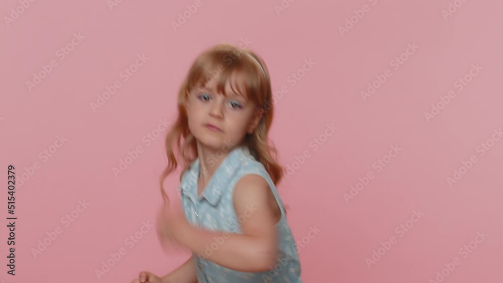 Aggressive preteen child girl kid making fight threat at camera ... 