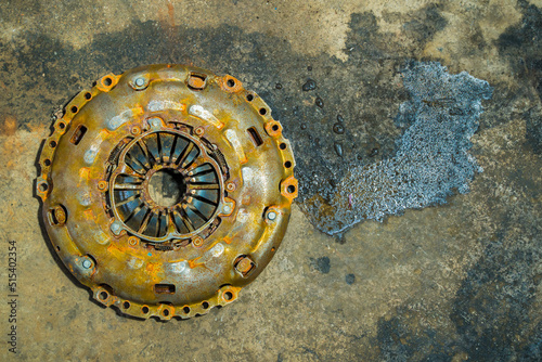 Clutch Cover expire on background gear transmission.expire on dirty background.There are rust stains.maintenance services clutch.