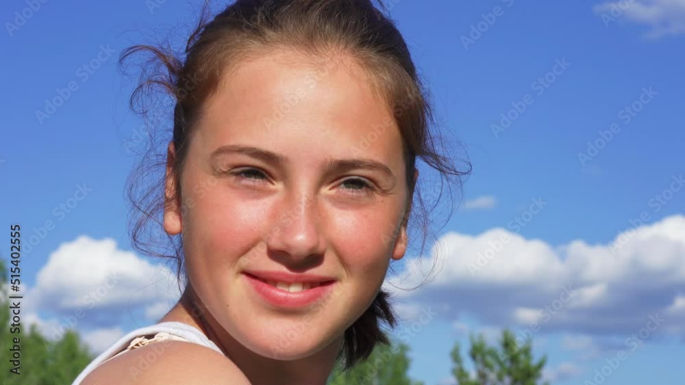 Portrait of a happy teenage girl outside on a sunny summer day Portrait of a happy teenage girl outside on a sunny summer day
