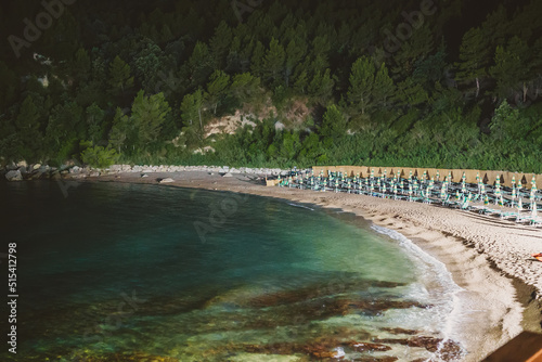 Sun loungers and umbrellas on the Sassolini beach. photo