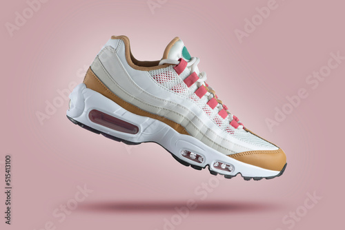 White sneaker with colored accents on a pink gradient background, men's fashion, sport shoe,  air, sneakers, lifestyle, concept, product photo,  levitation concept, street wear, trainer
