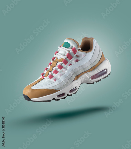 White sneaker with colored accents on a green gradient background, men's fashion, sport shoe,  air, sneakers, lifestyle, concept, product photo,  levitation concept, street wear, trainer photo
