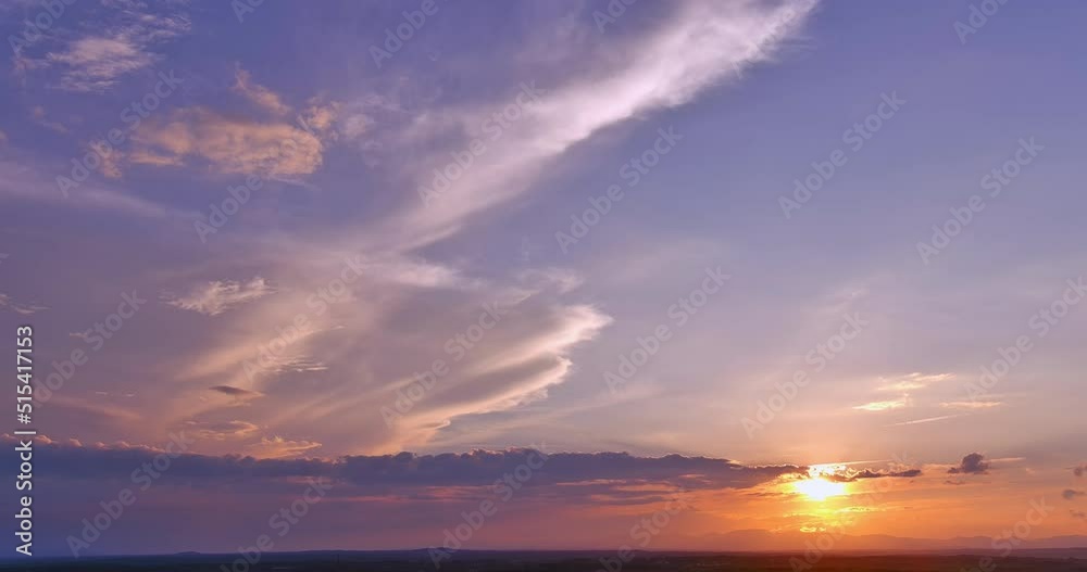 Through the clouds, the sun creates a beautiful orange light sunset in gorgeous panorama view Through the clouds, the sun creates a beautiful orange light sunset in gorgeous panorama view