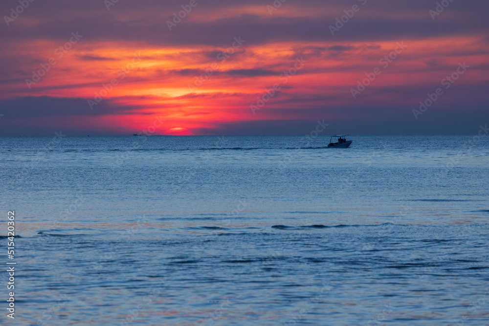 Colorful sea sunset with a boat