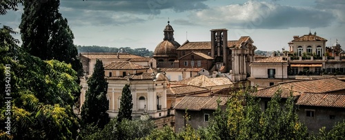 Photography Panoramic view of the unique architecture of Rome under a cloudy sky, Italy