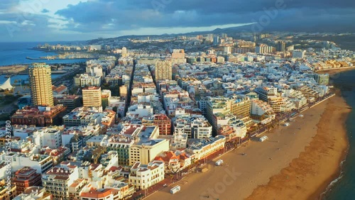 Las Palmas de Gran Canaria aerial view from above in sunset time. Amazing cityscape of Canary Islands capital. Long urban beach and residential area. Travel holidays destination concept