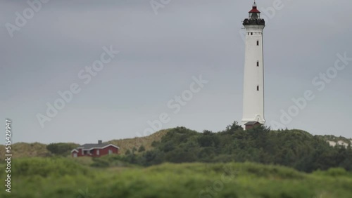 Lyngvig Lighthouse in a scenic setting. Slow-motion, pan follow. photo