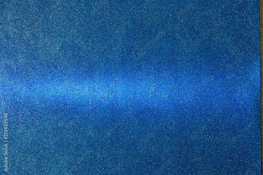 Fototapeta premium On a blue lacy gradient background in fine grain, a light blue horizontal beam of light