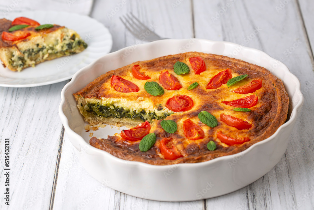 Vegetarian homemade pie, Quiche with tomatoes, spinach and feta cheese, spinach quiche (Turkish name; ispanakli kis) Vegetarian homemade pie, Quiche with tomatoes, spinach and feta cheese, spinach quiche (Turkish name; ispanakli kis)