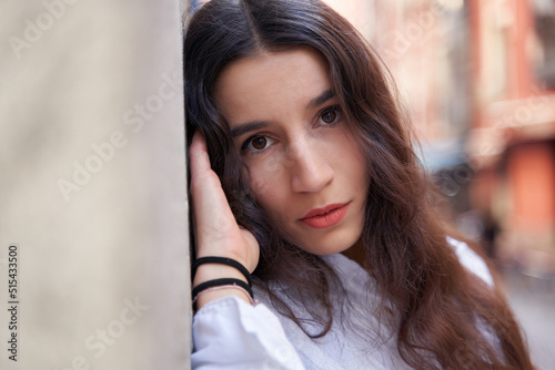 close-up portrait of a young caucasian woman with long hair looking at camera