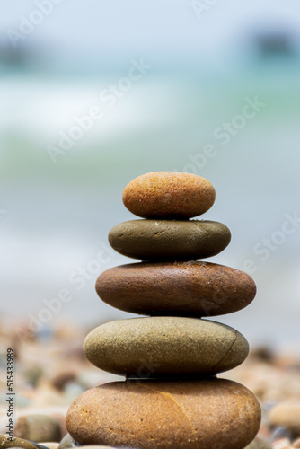 Pyramid stones balance on the beach. Calm. Zen-like concept.