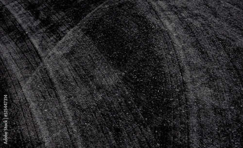 Abstract pattern background image. concrete surface. Modern black tones. Wheel marks on the floor.