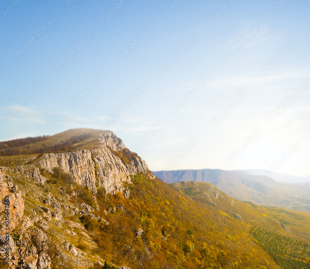 mountain cliff in light of early morning sun