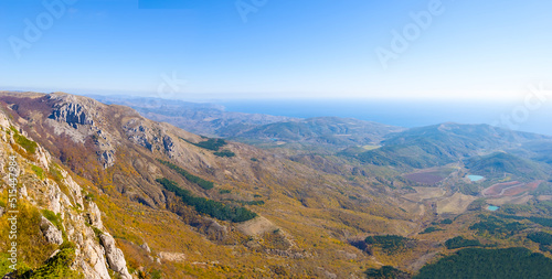 view from mountain ridge to valley under blue sky © Yuriy Kulik