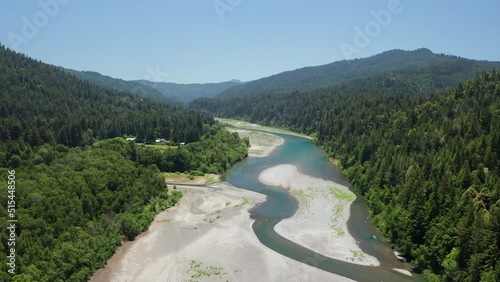 Aerial scenic shot of river between giant redwood sequoia trees in Humboldt photo