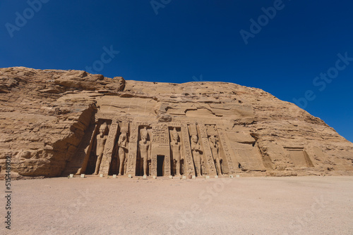 The main view of an Entrance to the Great Temple at Abu Simbel with Ancient Colossal statues of Ramesses II  seated on a throne and wearing the double crown of Upper and Lower Egypt