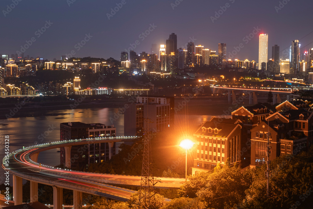Naklejka premium At night, the circular overpass and the urban skyline are in Chongqing, China