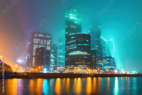 Canvas Print Modern high-rise illuminated buildings in Moscow covered by fog at night