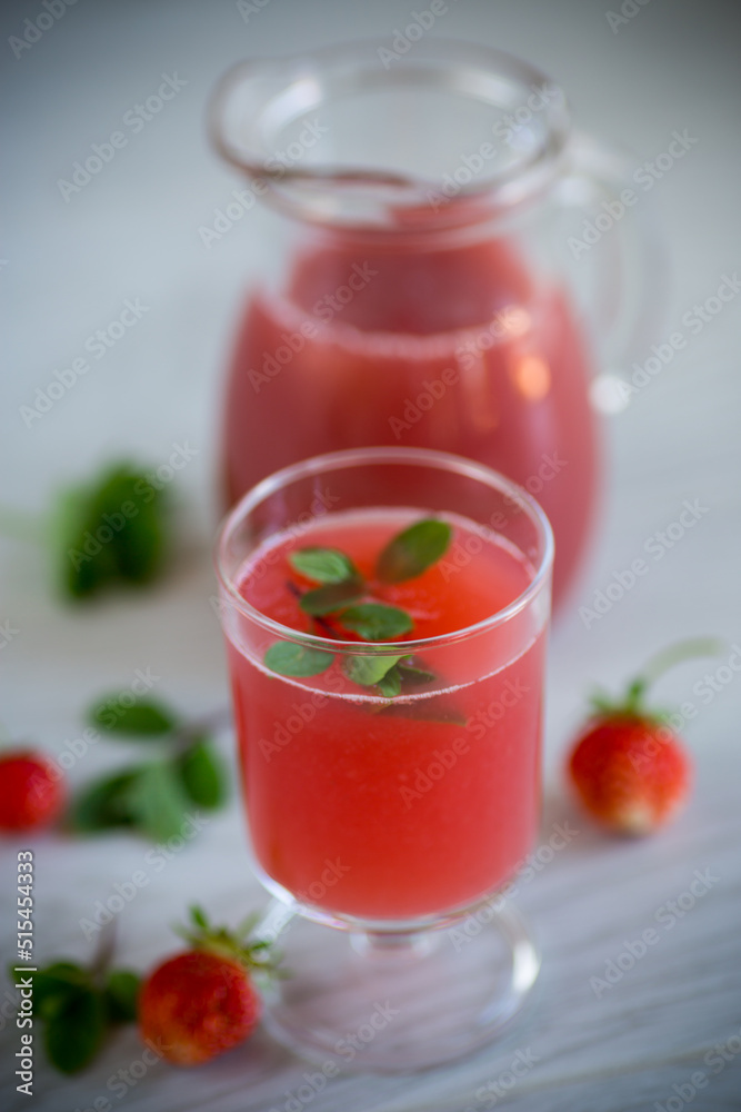 Cold summer strawberry kvass with mint in a glass Cold summer strawberry kvass with mint in a glass