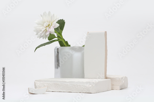 Stack stones platform podium and flower on gray light copy spase background. Minimal empty display product presentation scene.