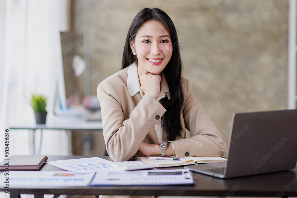 Asian Businesswoman working on laptop at the office with documents on his desk, doing planning analyzing the financial report, business plan investment, finance analysis concept Asian Businesswoman working on laptop at the office with documents on his desk, doing planning analyzing the financial report, business plan investment, finance analysis concept