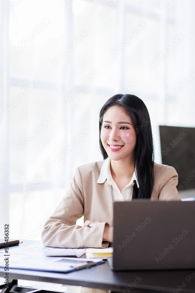 Asian Businesswoman working on laptop at the office with documents on his desk, doing planning analyzing the financial report, business plan investment, finance analysis concept Asian Businesswoman working on laptop at the office with documents on his desk, doing planning analyzing the financial report, business plan investment, finance analysis concept