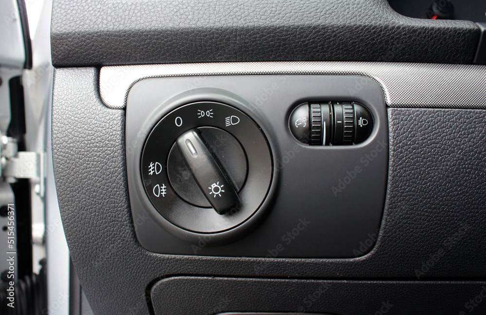 Car fog lights switch. Light switch in modern car. Modern car headlight controls. Automobile interior detail. Car fog lights switch. Light switch in modern car. Modern car headlight controls. Automobile interior detail.