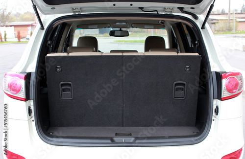 Open back door modern SUV. Clean  open empty trunk in the grey car. Rear view of the car open trunk. Opened empty car trunk.