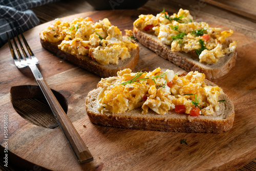 Scrambled eggs on a slice of bread.