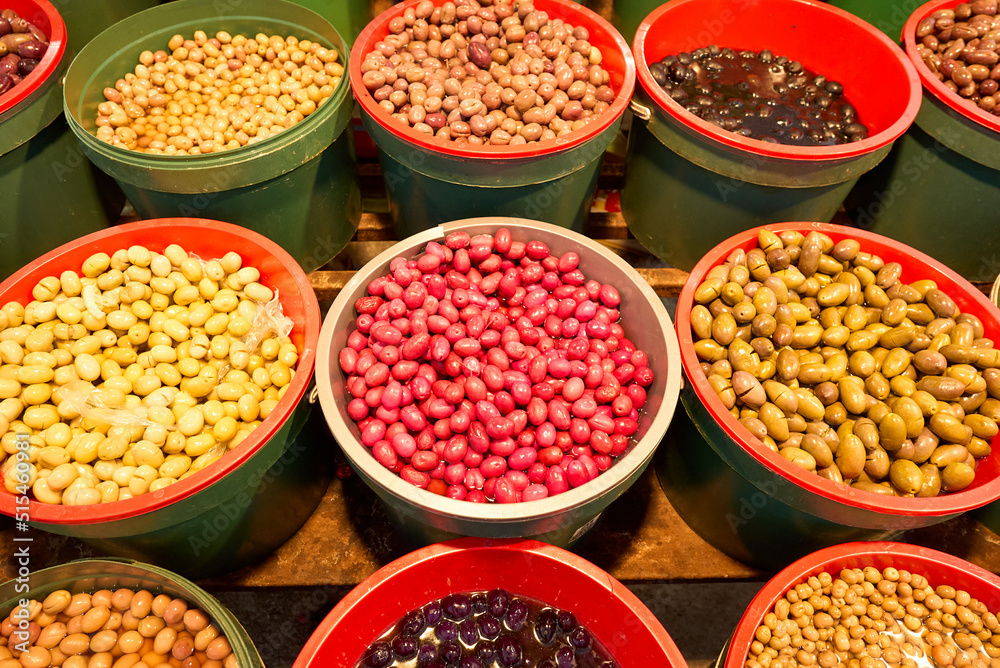 A pile of shiny Syrian green olives, full of oil. No kernels. Blurred background. Arabic style. The Old Market of Mahane Yehuda, Jerusalem. High quality photo A pile of shiny Syrian green olives, full of oil. No kernels. Blurred background. Arabic style. The Old Market of Mahane Yehuda, Jerusalem. High quality photo