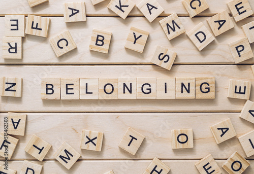 Obraz na plátně Word Belonging made with letter blocks on wooden background