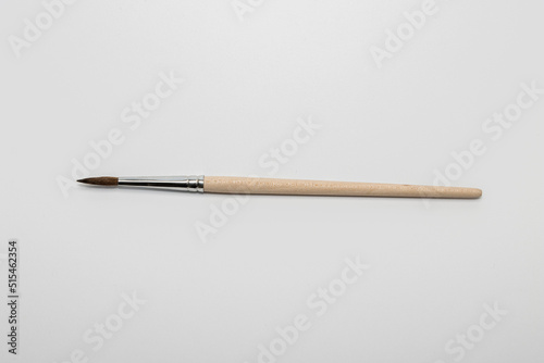 a thin needle brush on the blank white paper background