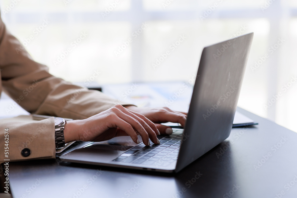 Close up Businesswoman hand typing on computer keyboard of a laptop computer in office. Business and finance concept. Close up Businesswoman hand typing on computer keyboard of a laptop computer in office. Business and finance concept.
