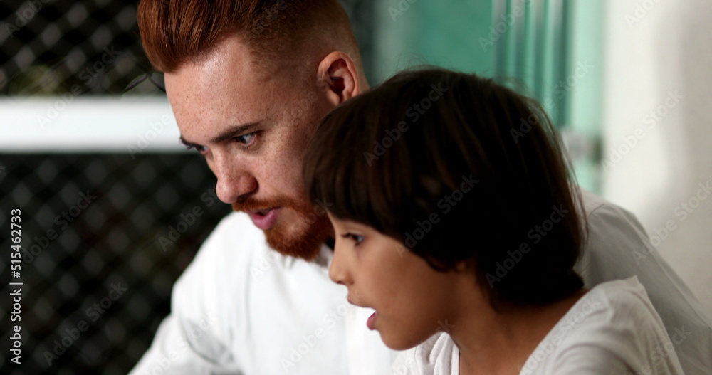 Parent and child bonding together in front of laptop computer. Ethnic diverse family Parent and child bonding together in front of laptop computer. Ethnic diverse family