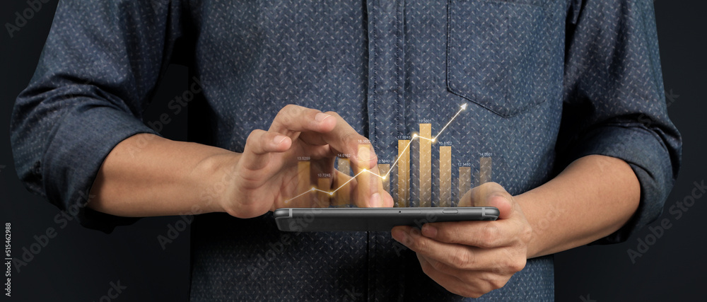 Hand holding smartphone device and touching screen. Stock exchange market concept Hand holding smartphone device and touching screen. Stock exchange market concept