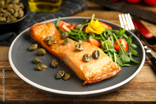 Wallpaper Mural Tasty cooked salmon with capers and salad served on wooden table, closeup Torontodigital.ca