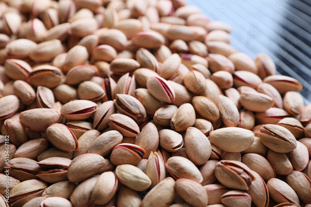 Many tasty pistachios on table, closeup view Many tasty pistachios on table, closeup view