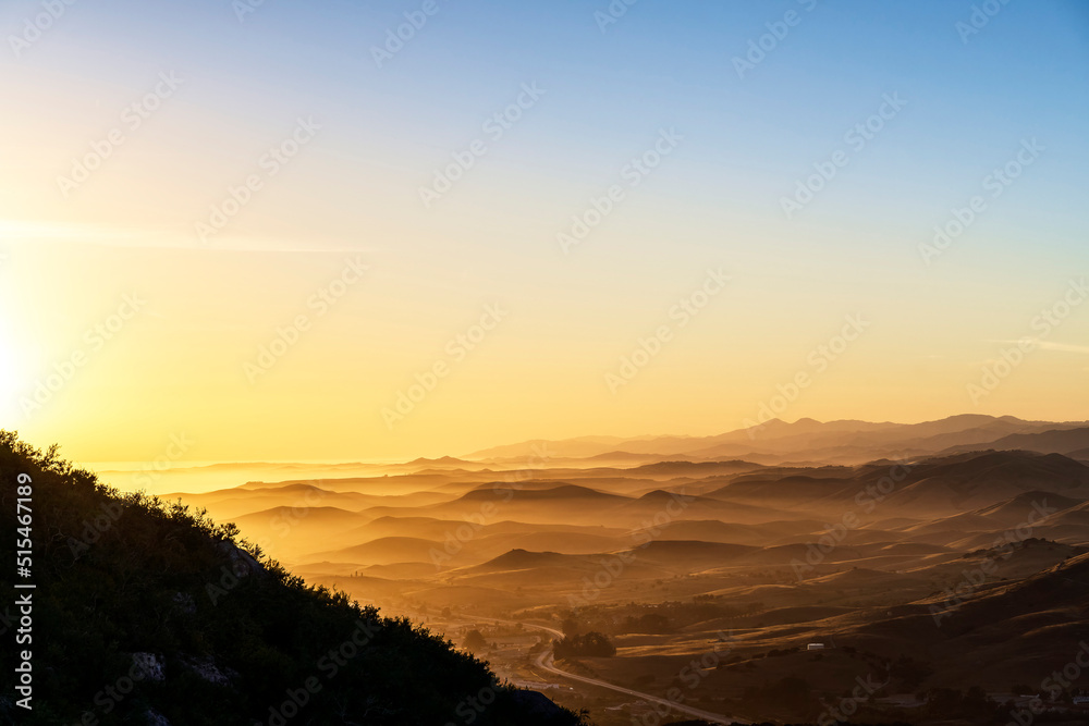 Sunset over hills, mountains, from above, view