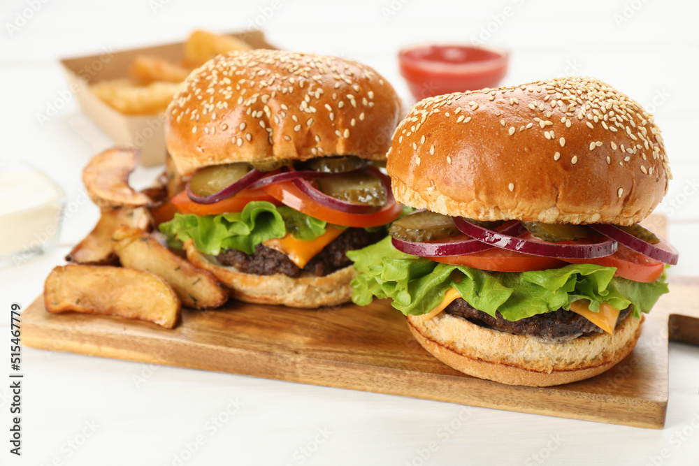 Tasty burgers served on white wooden table, closeup. Fast food Tasty burgers served on white wooden table, closeup. Fast food