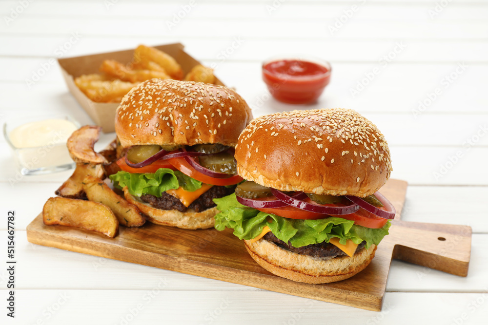 Tasty burgers served on white wooden table, closeup. Fast food