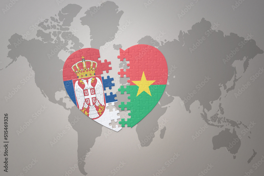 puzzle heart with the national flag of burkina faso and serbia on a world map background.Concept.