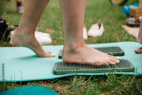 Alternative medicine and mindfulness practice - standing on sadhu board nails barefoot