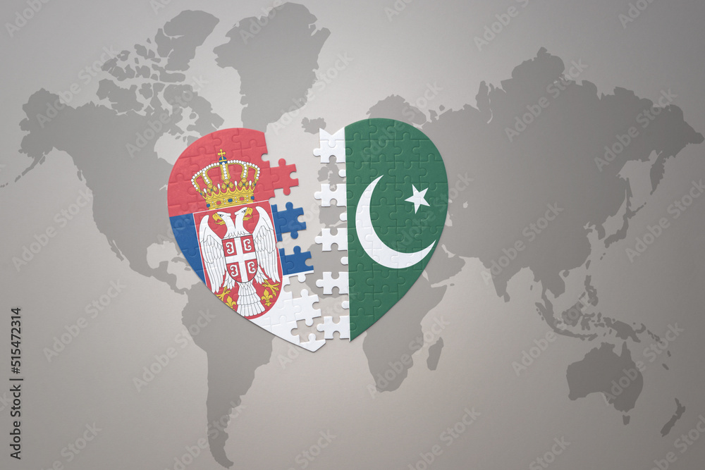 puzzle heart with the national flag of pakistan and serbia on a world map background.Concept.
