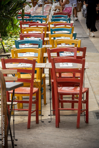 Clolored Wooden Chairs on Sidewalk in the City of Cagliari, in the Region of Sardinia, Italy, in Summer © daniele russo