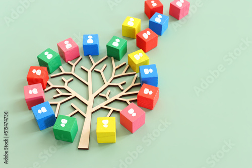 Business image of wooden tree with people icons over green background  human resources and management concept