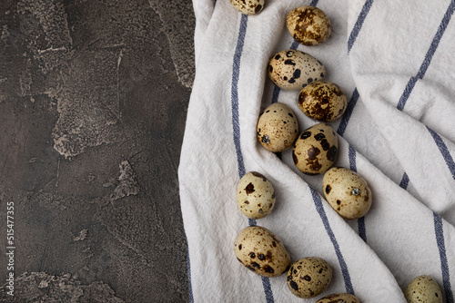 Quail eggs on a black texture background. Whole and broken quail eggs. Natural products. Place for text. Fresh quail eggs.