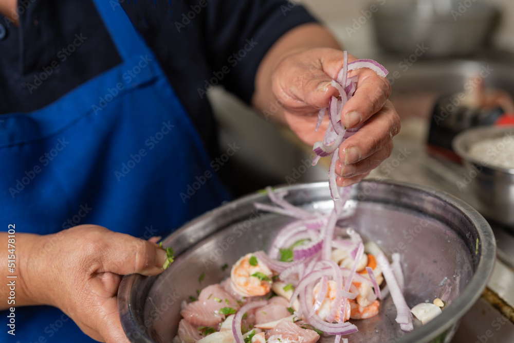 Cook mixing ingredients for a ceviche